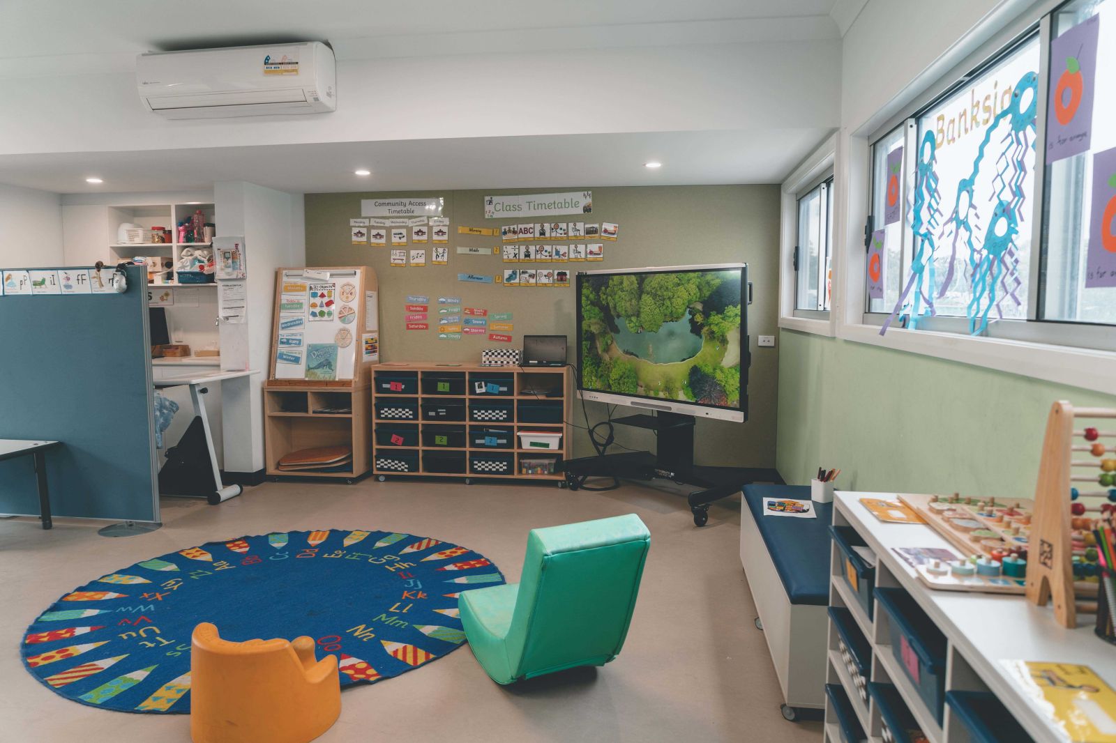 A colorful and inviting classroom designed for young learners, featuring a mix of educational and play spaces.